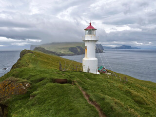 Fototapeta na wymiar Panoramic view of Old lighthouse on the beautiful island Mykines, Faroe islands, Denmark