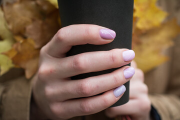 Big cup of coffee and female hands