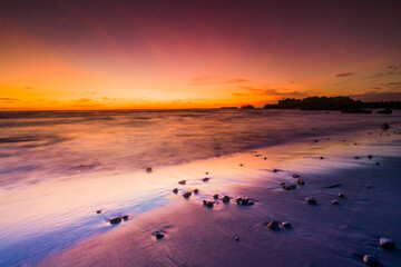 Obraz premium Beautiful Mengening Beach Sunset in Canggu Bali and Golden Hours at Sky with Black Sand Reflection Color