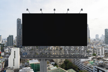 Blank black road billboard with Bangkok cityscape background at day time. Street advertising poster, mock up, 3D rendering. Front view. The concept of marketing communication to promote or sell idea.