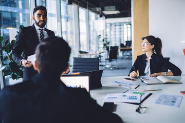 Successful business partners sharing ideas during conference in office
