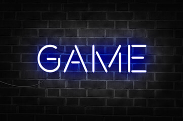 Fototapeta na wymiar Blue neon sign of the word GAME on dark brick wall.