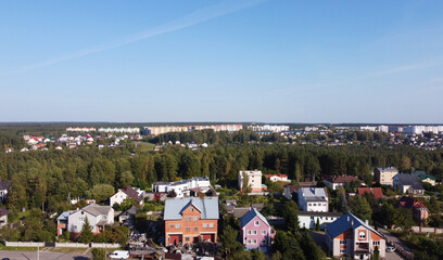 Top view of suburban villas near the park. Landscape with roofs of small houses