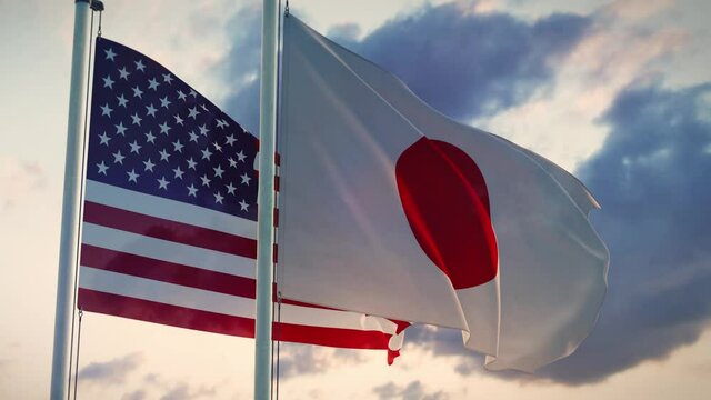 United states and Japan flags on a flagpole depict trade agreements and negotiations.