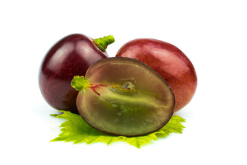 Pink grapes on a green leaf isolated on white background.