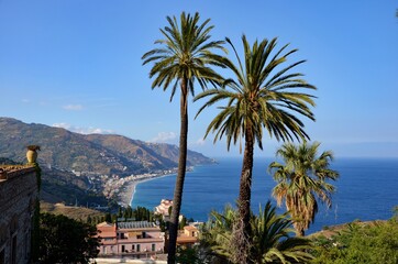 Fototapeta na wymiar View from Taormina cable car station towards the Bay of Spinsone, mediterranean sea
