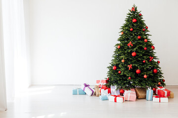 Christmas tree pine with red decor with gifts interior postcard for the new year