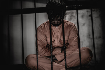 Asian man desperate at the iron prison,prisoner concept,thailand people,Hope to be free,Serious...