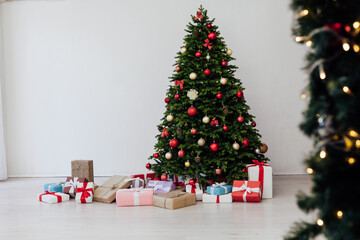 Christmas tree with gifts pine new year decor interior of the house postcard