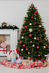 Christmas tree with gifts pine new year decor the interior of the white room of the house postcard