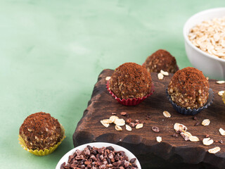Protein energy balls with cocoa, dried fruit, nut butter and seeds. Healthy dessert, snack.
