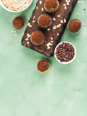 Protein energy balls with cocoa, dried fruit, nut butter and seeds. Healthy dessert, snack, flat lay