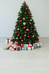 Christmas tree pine with gifts new year decor garland interior of the holiday house December