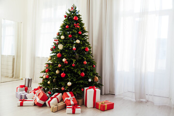 Winter Christmas tree pine with gifts new year decor garland interior of the holiday home December