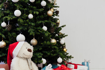 Winter Christmas tree pine with gifts new year decor garland interior of the holiday home December