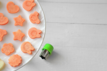 funny food for picky eaters kids. carrots cut in various shapes, bunny, stars and flowers made of...