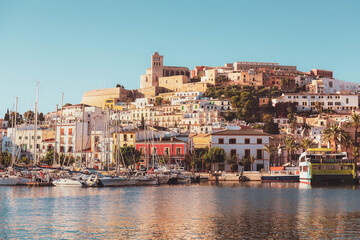 Selective focus on building, beautiful Ibiza old town with blue Mediterranean sea and city view in the morning