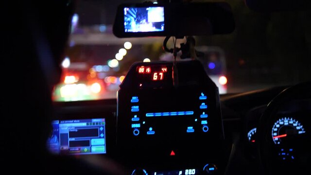 Night taxi ride in city, illuminated taxi meter and dashboard inside car with blurred city lights bokeh, urban transportation and nightlife travel concept
