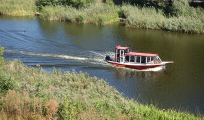Motorboat ride on a small river on a summer day
