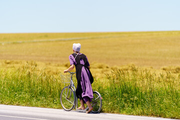 Bare feet Amish Girl Uses Bicycle Scooter