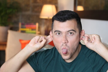 Mischievous young man at home 