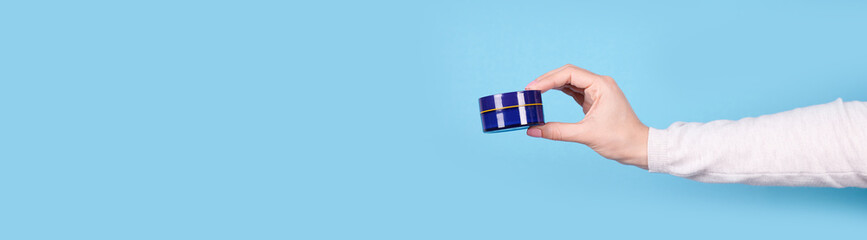 Cream in jar in hand, copy space template, banner.