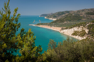 Fototapeta na wymiar Blue water, cliffs and a fish farm in Puglia, Italy