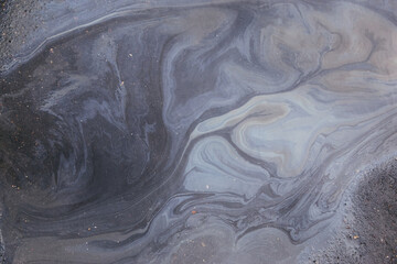 Spills and oil pollution on the road Leads to beautiful patterns and colors.