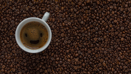 Flat lay of coffee cup smile on dark roasted arabica coffee beans background copy space