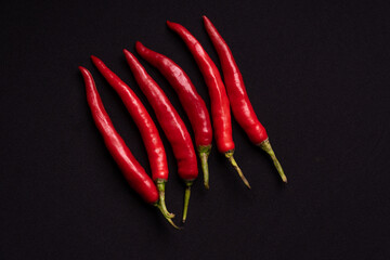 Fresh red chilies on a black background