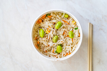 Take Away Boiled Steamed Basmati Rice with Edamame Beans in Plastic Cup Box Container.