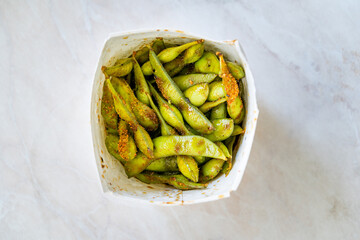Take Away Steamed Edamame Bean, Green Soybean in a pan, East Asian Cuisine.