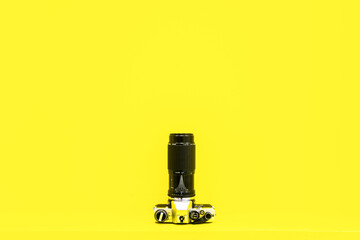 Vintage grey camera  view from up in yellow background