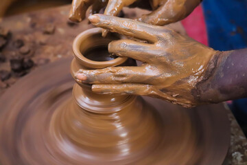 Hands And Fingers Posture Of Potter Making Pottery From Mud Using Spinning Potter Wheel