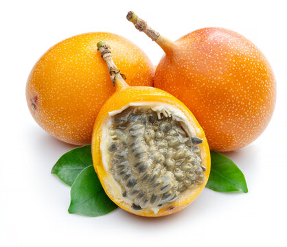 Granadilla with leaves and passion fruit half isolated on a white background.