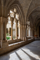 View of Gothic arches of the cloister of the Poblet monastery in Tarragona, Spain, vertical