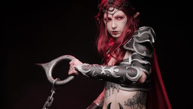A costume on a girl for Halloween in the form of a warlike elf on a black background with smoke.