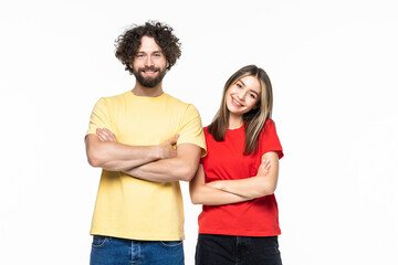 Fototapeta premium Portrait of happy couple standing with arms crossed isolated on white background