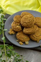 large plate of oatmeal cookies and a sprig of eucalyptus