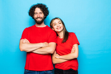 Fototapeta premium Portrait of couple with arms crossed not smiling wear casual red t-shirts isolated blue background