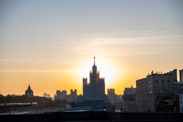 Fototapeta na wymiar cityscape with ancient buildings and skyscrapers at sunrise