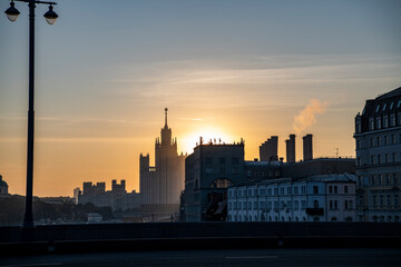 Obraz premium cityscape with ancient buildings and skyscrapers at sunrise