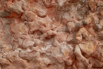 Stone texture with smooth shapes of reddish color