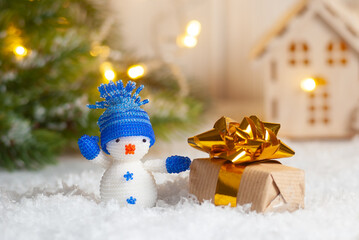 Christmas toy decoration snowman with present box. Beautiful winter holiday new year greeting card