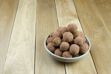 Homemade energy sweet balls-sweets with dried apricots, raisins, dates, prunes, walnuts, cashews and coconut. Indian vegetarian desserts. Healthy sweet food for tea drinking.