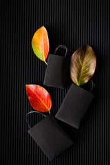 Paper bag with orange leaves. Black friday. Autumn shopping. Seasonal sale 