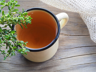 Medicinal plant Polygonum Hydropiper and herbal tea in an enamel mug on a wooden stand. Useful...