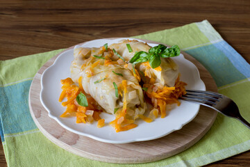 Meat stuffed cabbage leaves on a white plate, close-up