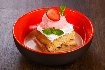 Cake with ice cream served stravberry