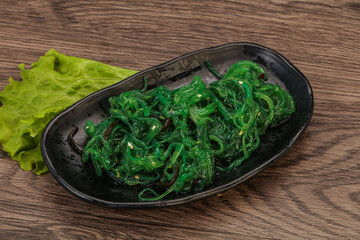 Green Chuka Seaweed Salad Isolated on White Background Top View. Wakame Sea Kelp Salat
